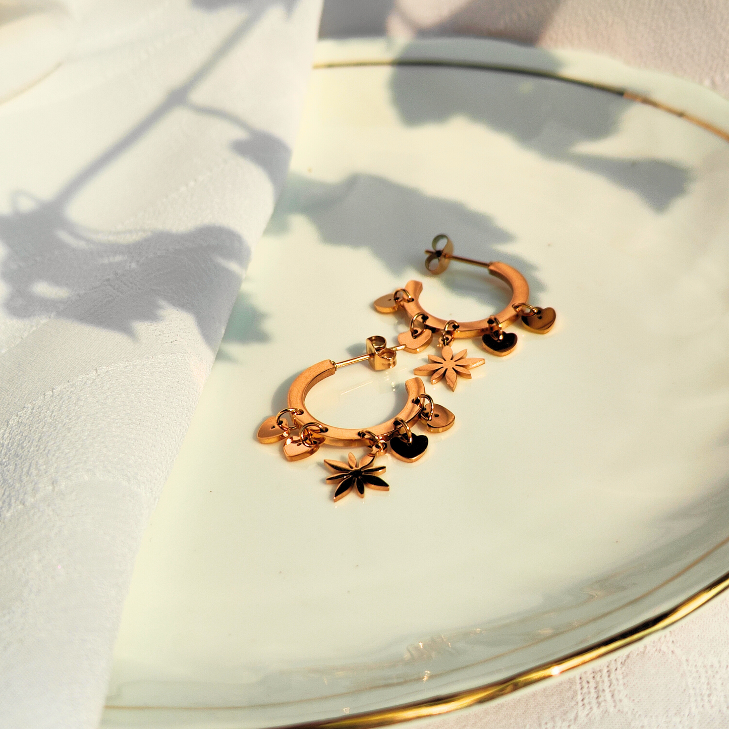 Celestial Heart Anti-tarnish Earrings kept on a plate, top side view 